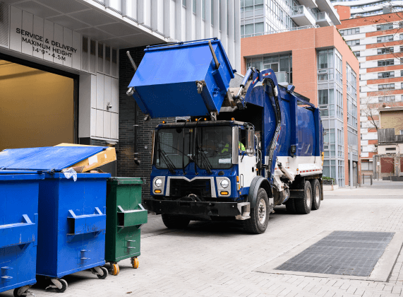 Waste management truck picking up a trash bin
