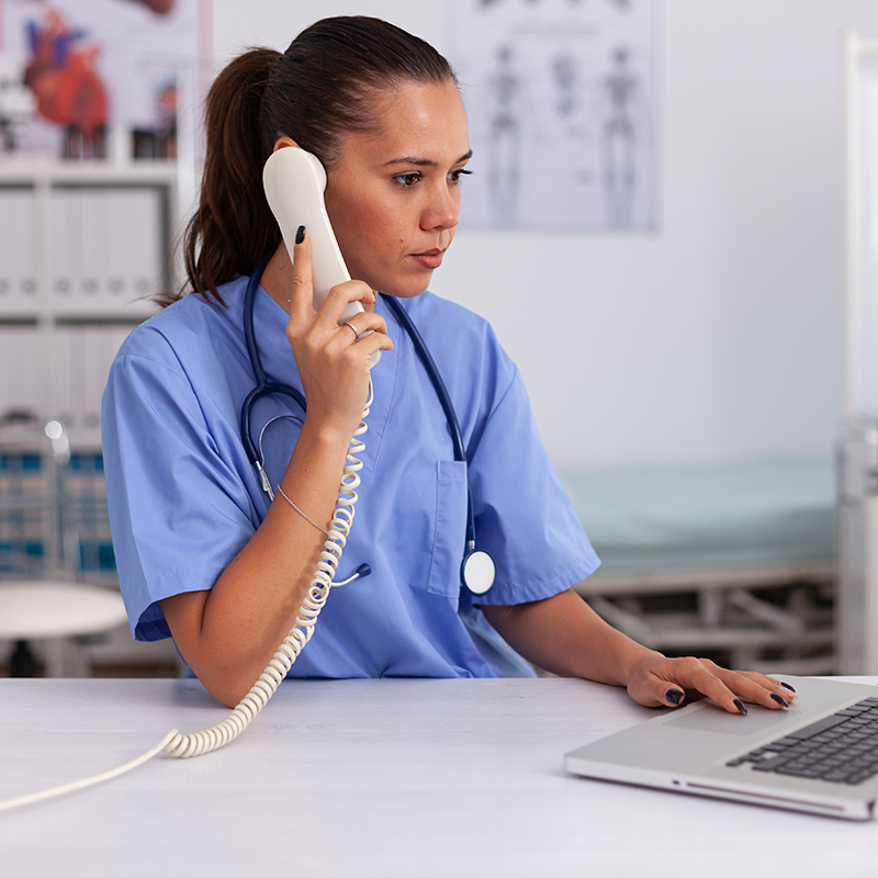 Medical billing specialist reviewing patient account balances at a clinic workstation